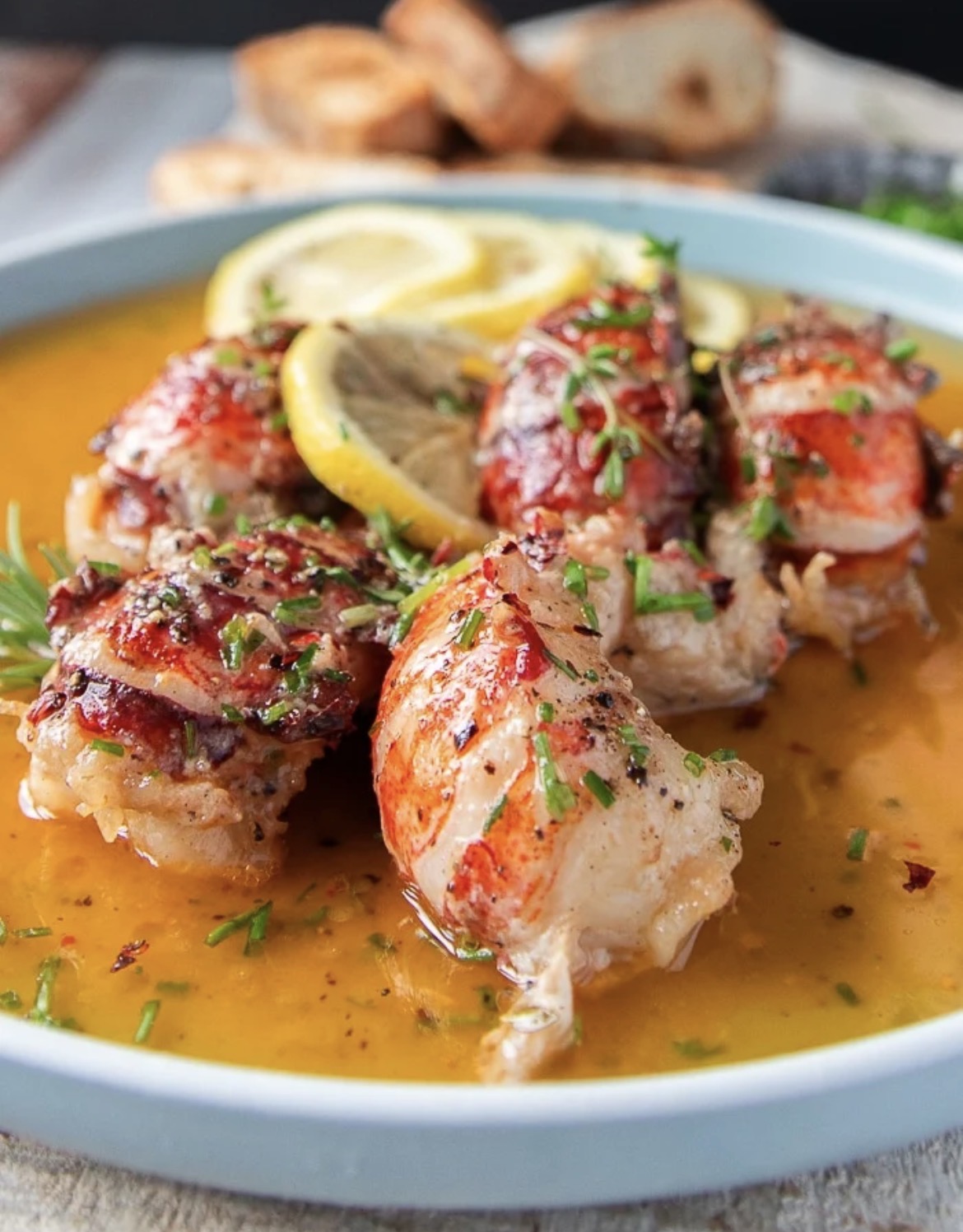 Butter poached lobster tails with lemon and herbs