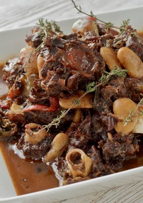 Stewed oxtails with butter beans and thyme