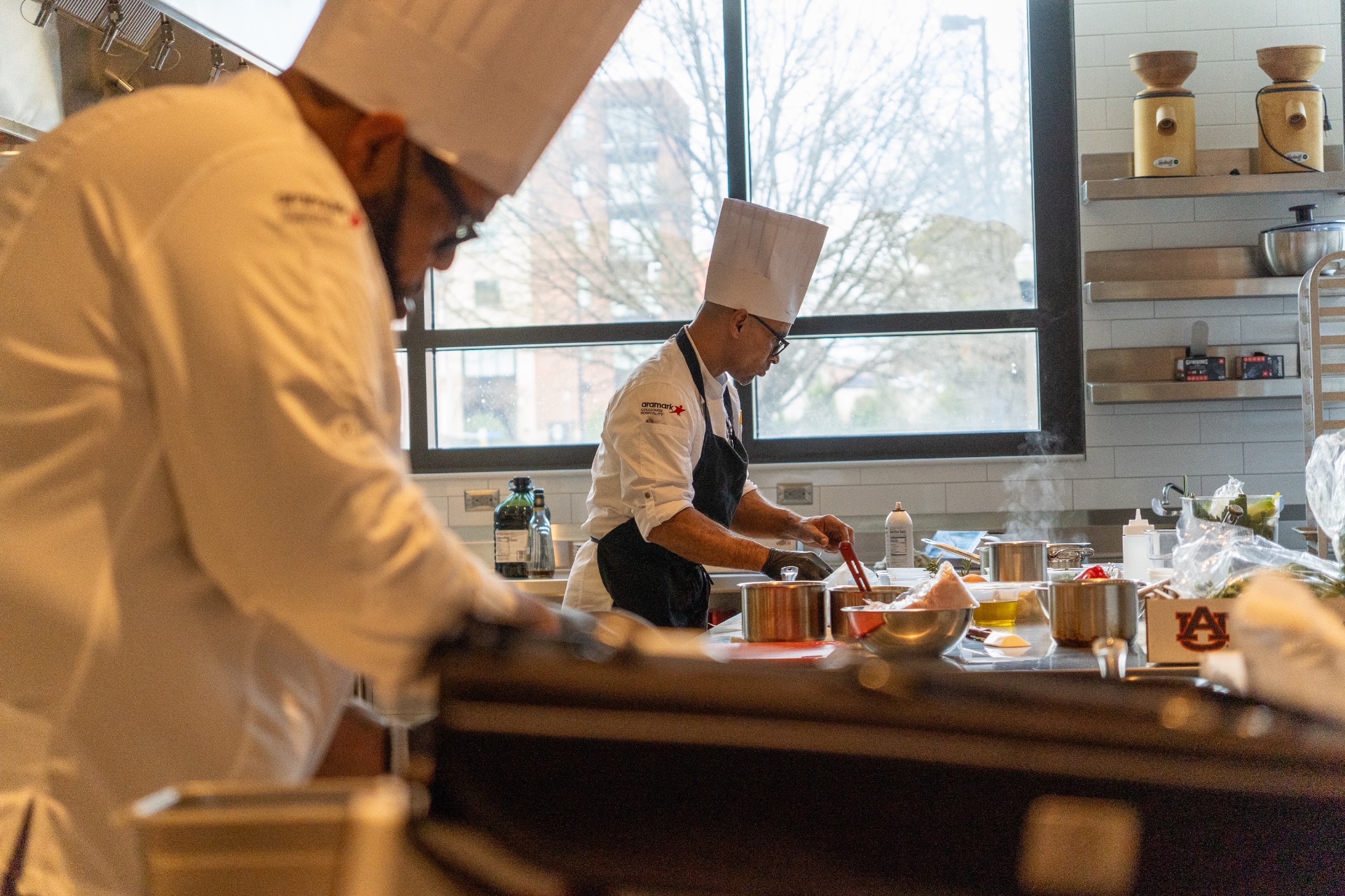 Chef O. cooking alongside Aramark culinary team