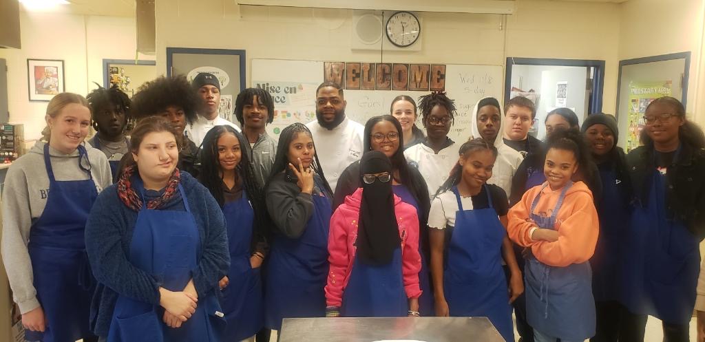 Chef O. mentoring student culinary class